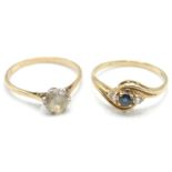A pair of 9ct rings. A solitaire ring with central white stone and pierced shoulders, stamped 9ct