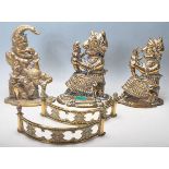 A pair of early 20th century brass Punch and Judy doorstops along with another brass doorstop and