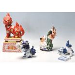 A group of early 20th century oriental Japanese ceramic figurines to include a large temple dog lion
