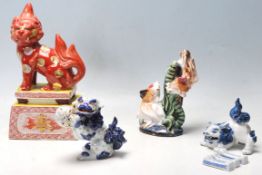 A group of early 20th century oriental Japanese ceramic figurines to include a large temple dog lion