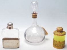 A collection of three vintage glass bottles/vessels comprising of a uranium green glass and