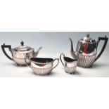 An Edwardian silver plated four piece tea set / coffee set, with part fluted decoration, the