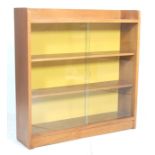 A vintage 20th century 1970’s teak wood Gibbs display cabinet has glass sliding doors, and gallery