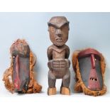 A group of three 20th century antique hand carved wooden figure and masks to include hardwood male