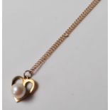 A hallmarked 9ct gold necklace and pendant having heart shape pendant with mother of pearl and a