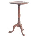 An 19th Century Georgian mahogany wine table occasional table having a lipped edge table top over