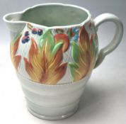 A CLARICE CLIFF WATER JUG WITH CELTIC LEAF AND BERRY PATTERN