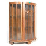 A retro vintage walnut veneer china display vitrine bookcase cabinet having a bow front with