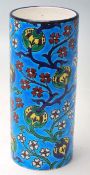 A FRENCH LONGWY CERAMIC VASE OF A CYLINDRICAL FORM WITH FLORAL