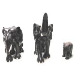 A collection of three antique 19th Century African ebony and ivory elephants of graduating height.