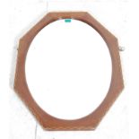 A 20th century Edwardian walnut marquetry wall mirror of a hexagonal form with oval bevelled mirror.