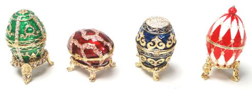 A group of vintage 20th century Russian enamelled Faberge style egg shape boxes with hinged lids,