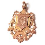 A hallmarked 9ct gold fob medal having an engraved G initial with the date 1907 and engraved foliate