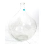 A vintage early 20th century large Indsutrial green glass acid carboy bottle of globular bulbous