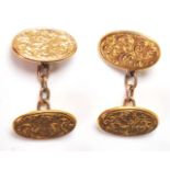 A pair of hallmarked 9ct gold cufflinks having oval heads with engraved folate decoration. Each head