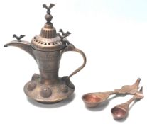 A 19TH CENTURY MIDDLE EAST BRASS COFFEE POT