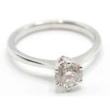 A STAMPED 18CT WHITE GOLD SINGLE STONE DIAMOND RING F AN ESTIMATED 70 POINTS.