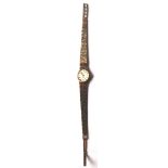 A 9ct gold ladies Rotary 21 jewels watch having a bark effect bracelet strap. Stamped to the edge.