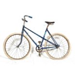 A vintage mid century Rally bicycle having white tires and blue painted frame with shaped handles