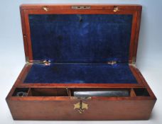 A 19th century Victorian oak writingslope box having brass decoration to the hinged lid opening to