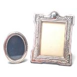 A silver hallmarked oval photo frame marked Sheffield 1989 by Carr’s of Sheffield Ltd, along with