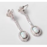 A PAIR OF STAMPED 925 SILVER DROP EARRINGS SET WITH CUBIC ZIRCONIAS AND OPALS.