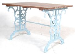 A RETRO VINTAGE 20TH CENTURY CAST IRON TABLE WITH SCROLED DECORATED BASE.