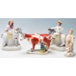 A group of four 19th century Victorian Staffordshire ceramic figurines to include a pair of his