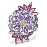 A LARGE STAMPED 925 SILVER FLOWER DRESS RING SET WITH AMETHYST AND CUBIC ZIRCONIA
