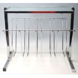 A RETRO 20TH CENTURY GRLASS AND CHROME MAGAZINE RACK.