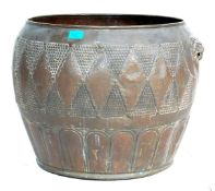 A large late 19th century Victorian copper plant pot of bulbous form with hand beaten decoration and