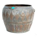 A large late 19th century Victorian copper plant pot of bulbous form with hand beaten decoration and