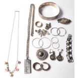 A collection of late 19th century and 20th century silver jewellery items to include brooches,