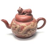 AN ANTIQUE CHINESE YIXING RED CLAY TEAPOT WITH HIDDEN DRAGONS WITH BLUE TURQUOISE EYES