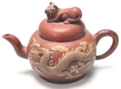AN ANTIQUE CHINESE YIXING RED CLAY TEAPOT WITH HIDDEN DRAGONS WITH BLUE TURQUOISE EYES