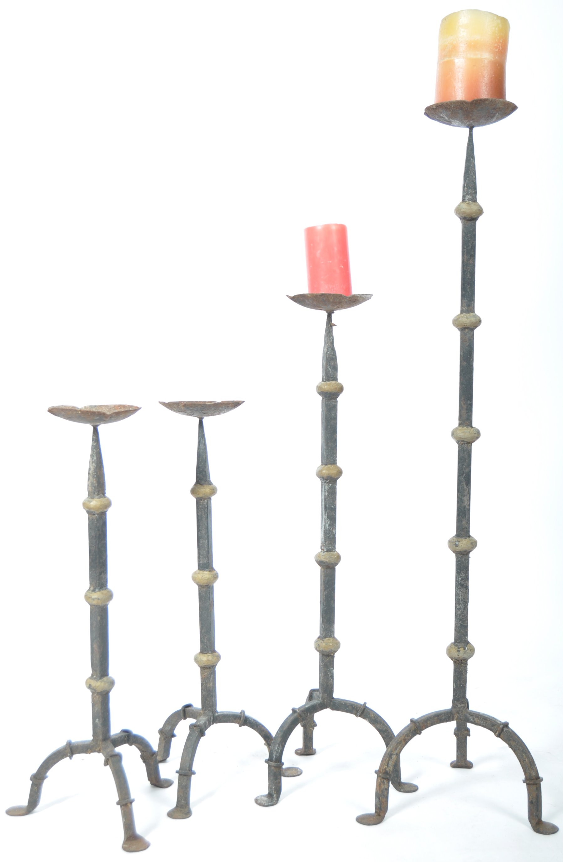GOOD GROUP OF FOUR VICTORIAN GRADUATING IRON WORK CANDLE HOLDERS