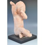AMERICAN TERRACOTTA SCULPTURE OF A CHILD WITH HAND RAISED