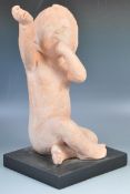 AMERICAN TERRACOTTA SCULPTURE OF A CHILD WITH HAND RAISED