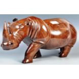 A STUNNING LARGER AND IMPRESSIVE HAND CARVED ROSEWOOD RHINO STATUE