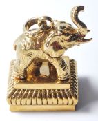 A METAL DOCUMENT SEAL HAVING AN ELEPHANT ATOP AND THE STAMP BEING OF A PROWLING LION.