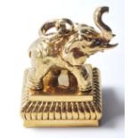 A METAL DOCUMENT SEAL HAVING AN ELEPHANT ATOP AND THE STAMP BEING OF A PROWLING LION.
