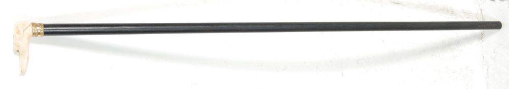 A 19TH CENTURY EBONISED WALKING STICK WITH AN EBONISED SHAFT.