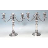 A PAIR OF 20TH CENTURY SILVER PLATED CANDLESTICKS.