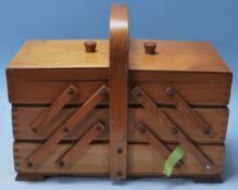 A VINTAGE MID CETURY RETRO ELM METAMORPHIC SEWING BOX