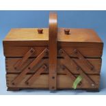 A VINTAGE MID CETURY RETRO ELM METAMORPHIC SEWING BOX