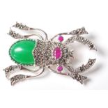 A STAMPED STERLING SILVER SCRAB BEETLE BROOCH SET WITH JADEITE.