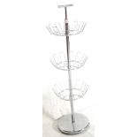 A RETRO 20TH CENTURY CHROME METAL REVOLVING SHOE RACK