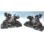 A PAIR OF EARLU 20TH CENTURY CHINESE BULL WITH A BOY SITTING ON HIS BACK