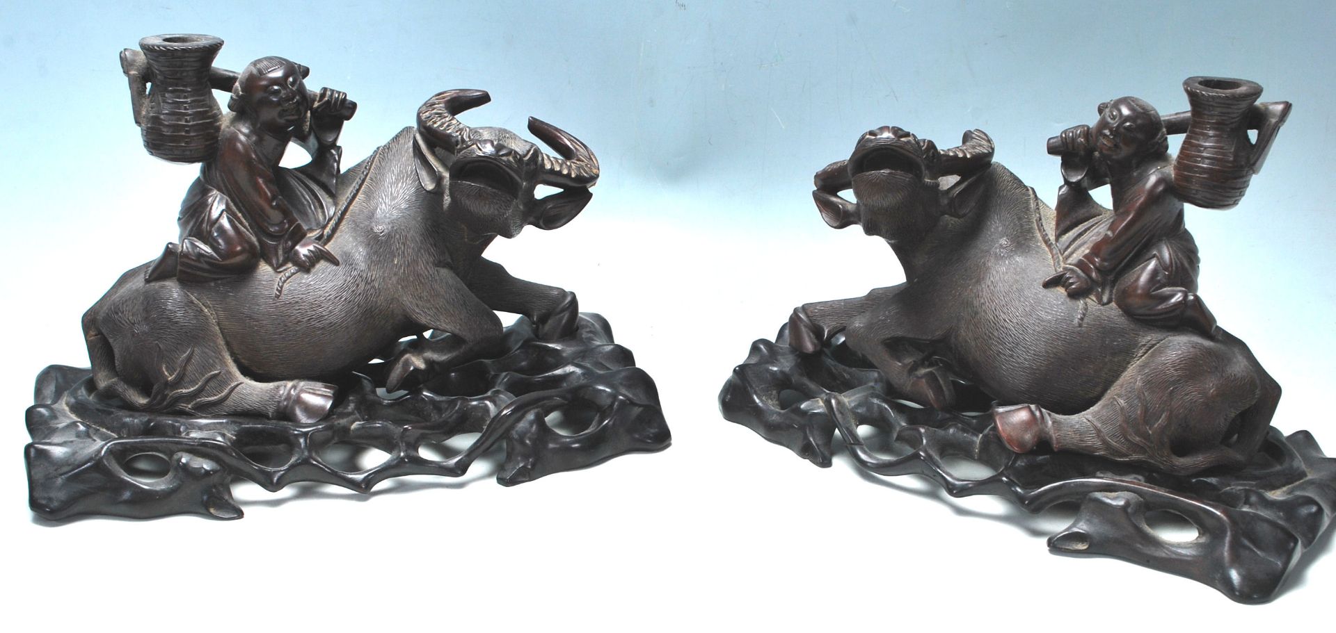 A PAIR OF EARLU 20TH CENTURY CHINESE BULL WITH A BOY SITTING ON HIS BACK