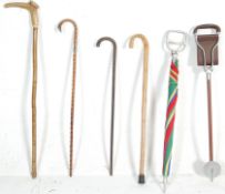 A GROUP OF RETRO WALKING STICKS AND SHOOTING STICKS